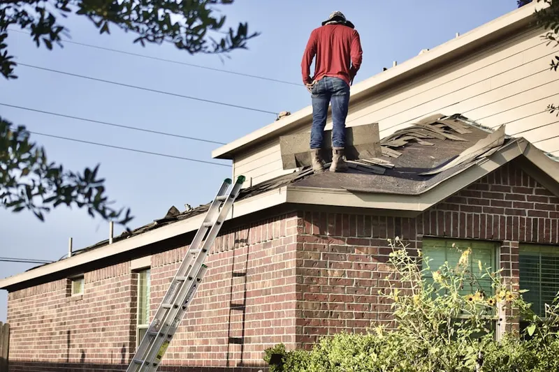 Professional roofer working on a residential roof in Smiths Mills
